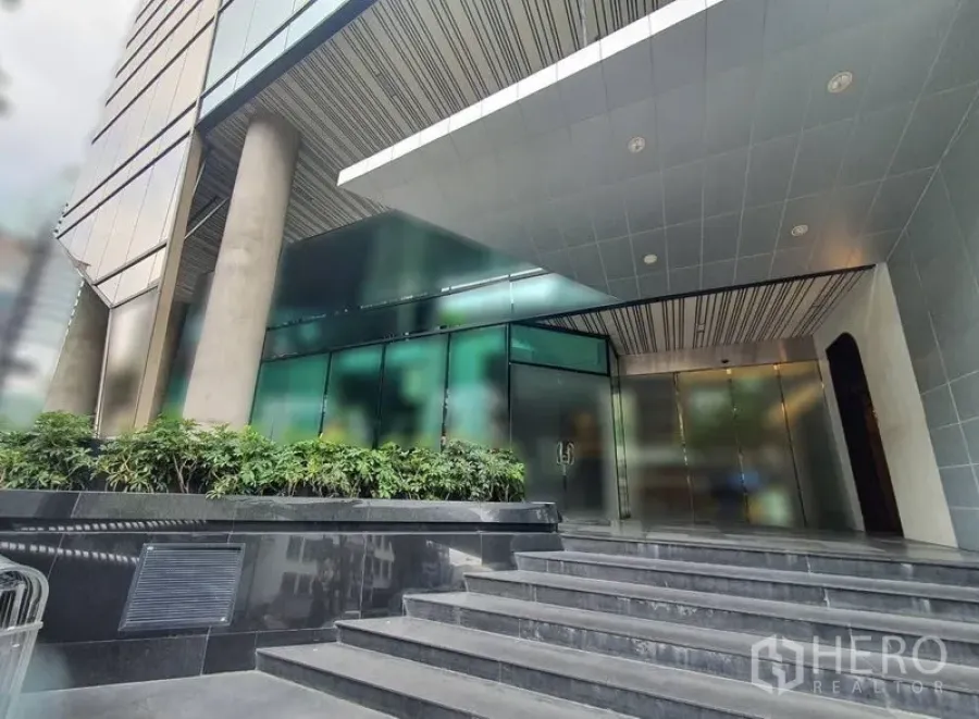 Retail Space for rent in Bang Rak, Bangkok - Contemporary glass entrance of CP Tower with steps and greenery in the Silom business district.