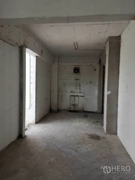 Retail Space for rent in Watthana, Bangkok - Raw corridor-style interior of the retail unit with exposed walls and basic lighting.