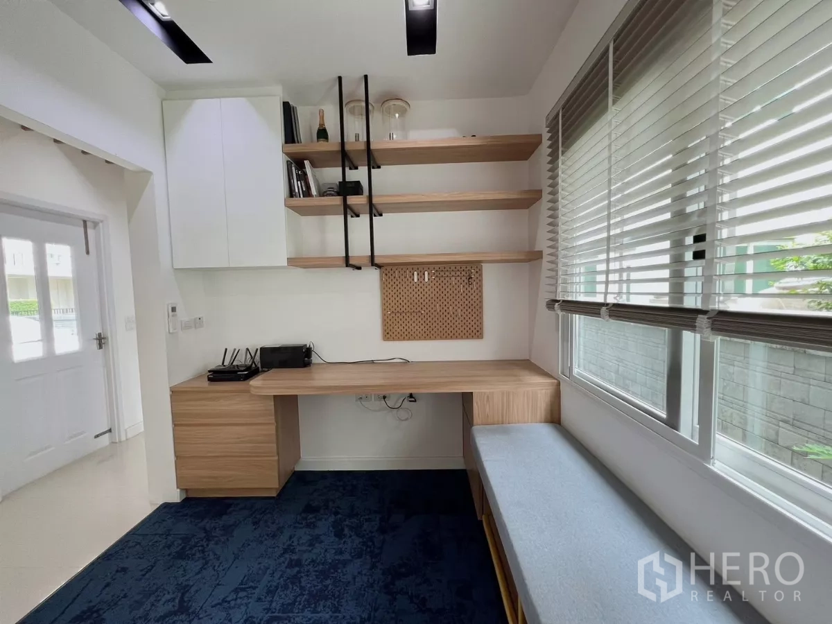 Detached House for rent or sale in Khlong Luang, Pathum Thani - Home office from another angle showing desk, storage and garden view.