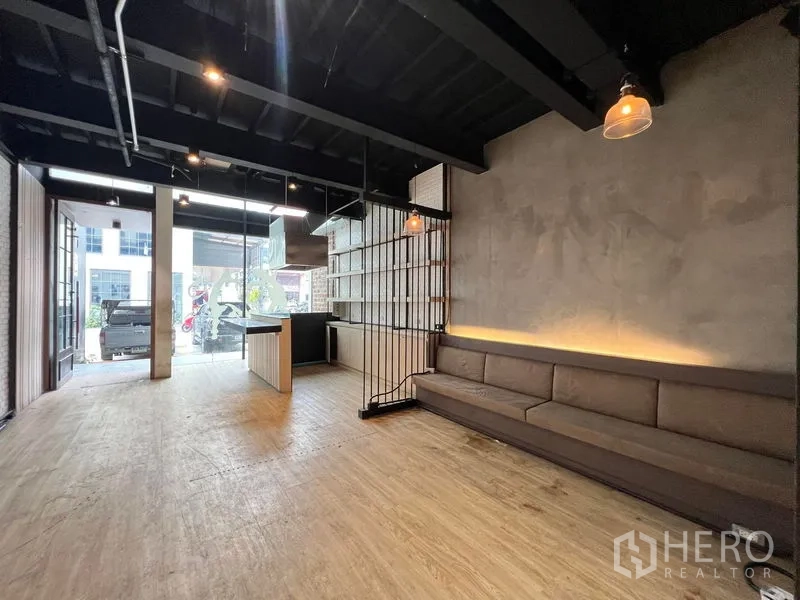 Shophouse for rent - Open-plan ground floor retail area with glass frontage, built-in bench and pendant lights.