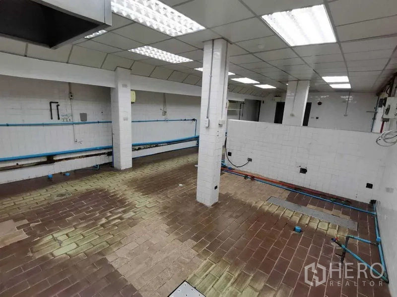 Retail Space for rent in Pathum Wan, Bangkok - White-tiled kitchen prep area with brown brick floor and utility connections.
