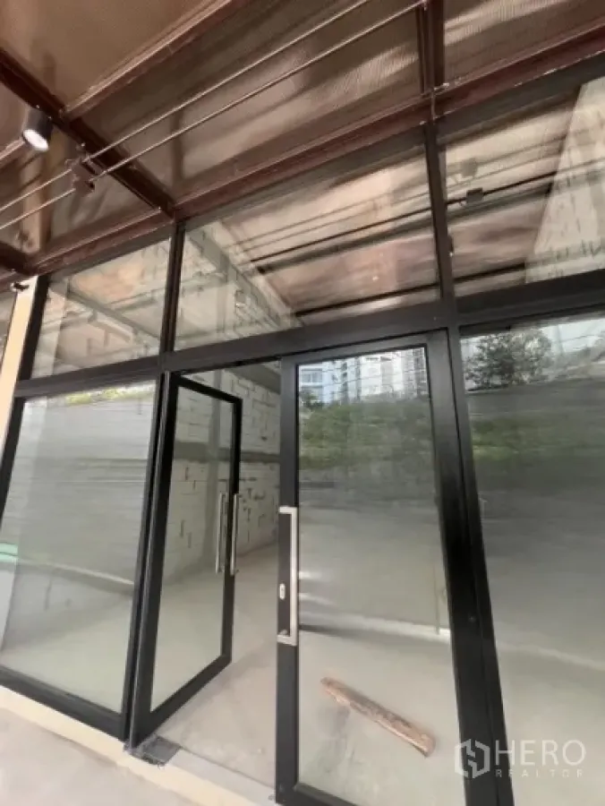 Retail Space for rent - Retail unit with floor-to-ceiling glass storefront and black metal frames, shell interior.