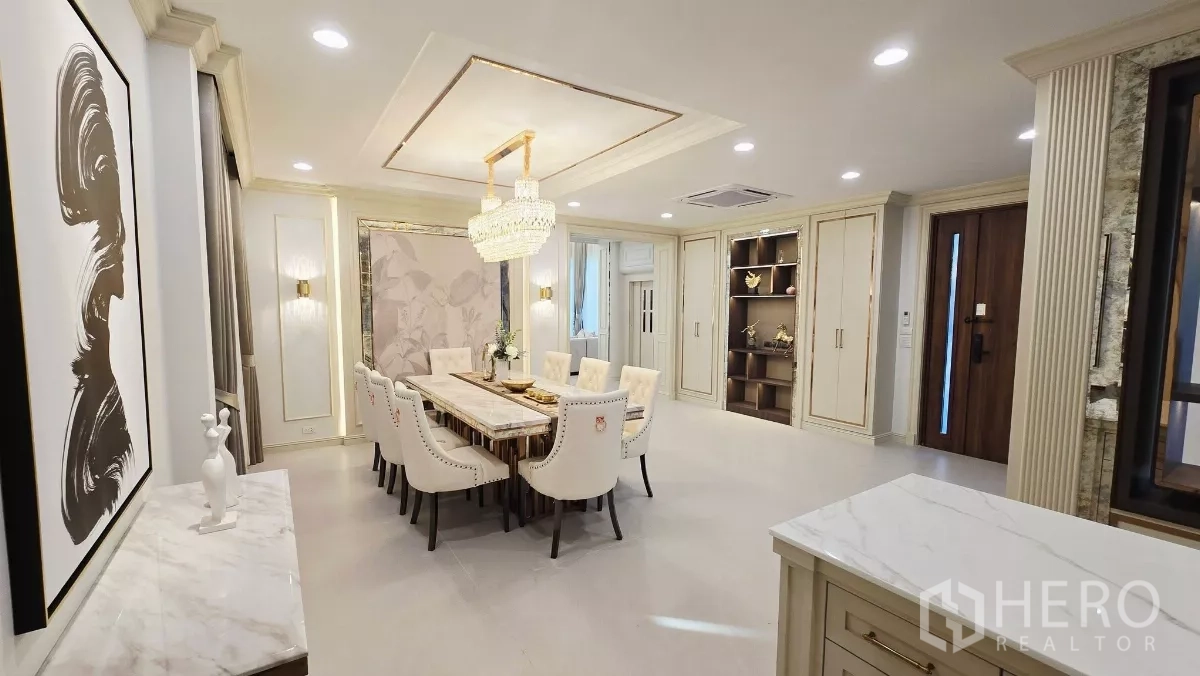 Detached House for rent in Prawet, Bangkok - Open-plan view from the kitchen to the dining room with a statement chandelier.