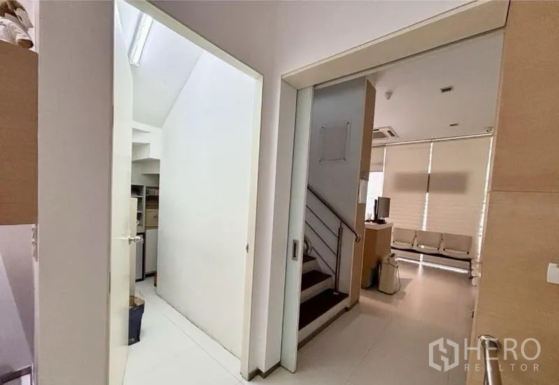 Home Office for rent in Watthana, Bangkok - Hallway with sliding door, stair access and an adjacent storage room.