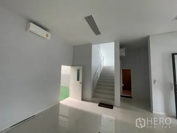 Factory for rent in Lam Luk Ka, Pathum Thani - Ground-floor lobby with staircase and side door to service area.