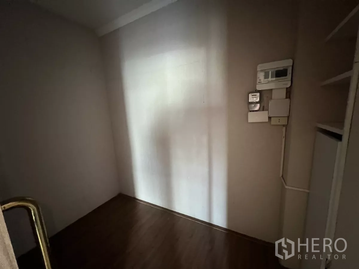 Retail Space for rent - Small storage room with electrical control panels on the wall.