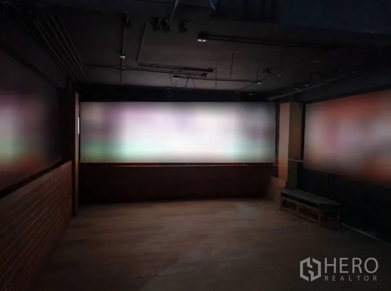 Shophouse for rent - Dim interior room with large frosted display windows and wood flooring suited for seating or showroom use.