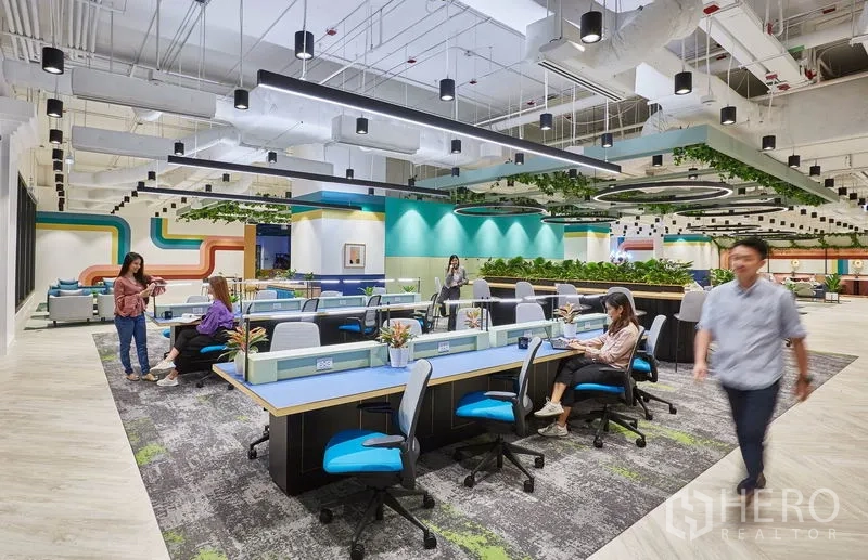 Office Space for rent in Pathum Wan, Bangkok - Open-plan workstations with ergonomic chairs, suspended lighting and greenery accents.