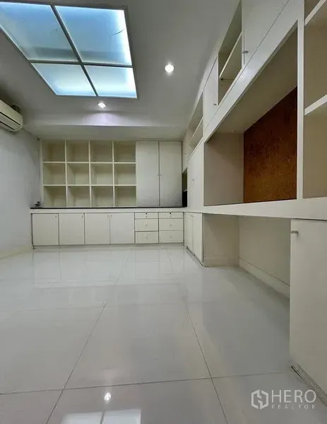 Home Office for rent in Suan Luang, Bangkok - Room with extensive built-in white cabinetry for office storage.