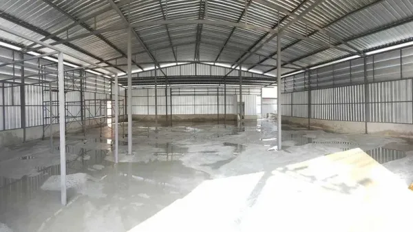 Warehouse for rent in Sai Mai, Bangkok - Spacious warehouse interior with high steel truss roof, open floor plan, and concrete floor.