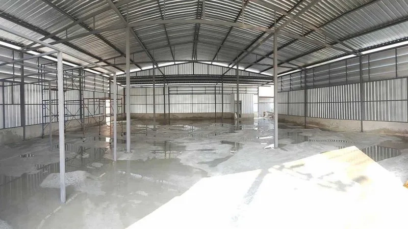 Warehouse for rent in Sai Mai, Bangkok - Spacious warehouse interior with high steel truss roof, open floor plan, and concrete floor.