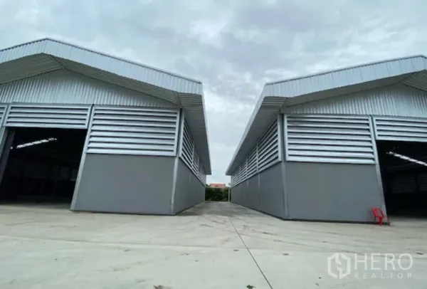 工厂 出租在Pathum Thani - 两栋平行仓厂建筑，配大型卷帘门与宽敞卡车通道，坐落于巴吞他尼工业用地内。