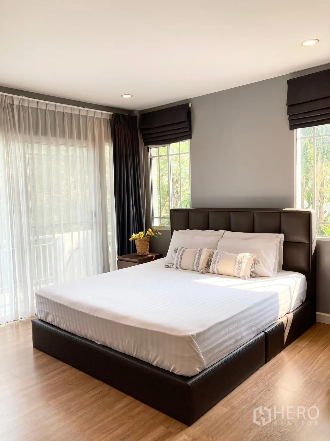 Detached House for rent in Prawet, Bangkok - Spacious master bedroom with large bed and sliding door with sheer curtains.