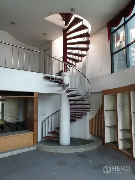 Office Space for rent in Suan Luang, Bangkok - Interior spiral staircase with metal railing connecting mezzanine levels.