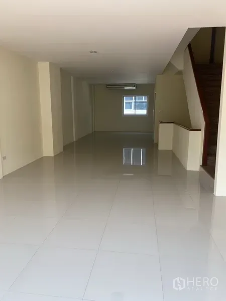 Home Office for rent in Yan Nawa, Bangkok - Long open-plan floor with polished tiles, recessed lighting and a wooden staircase.