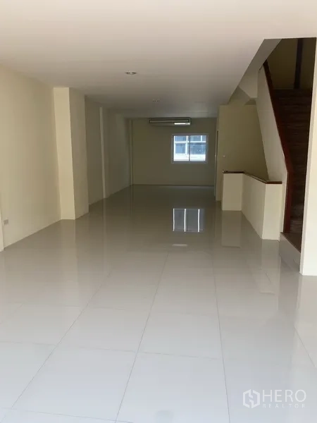 Home Office for rent in Yan Nawa, Bangkok - Long open-plan floor with polished tiles, recessed lighting and a wooden staircase.