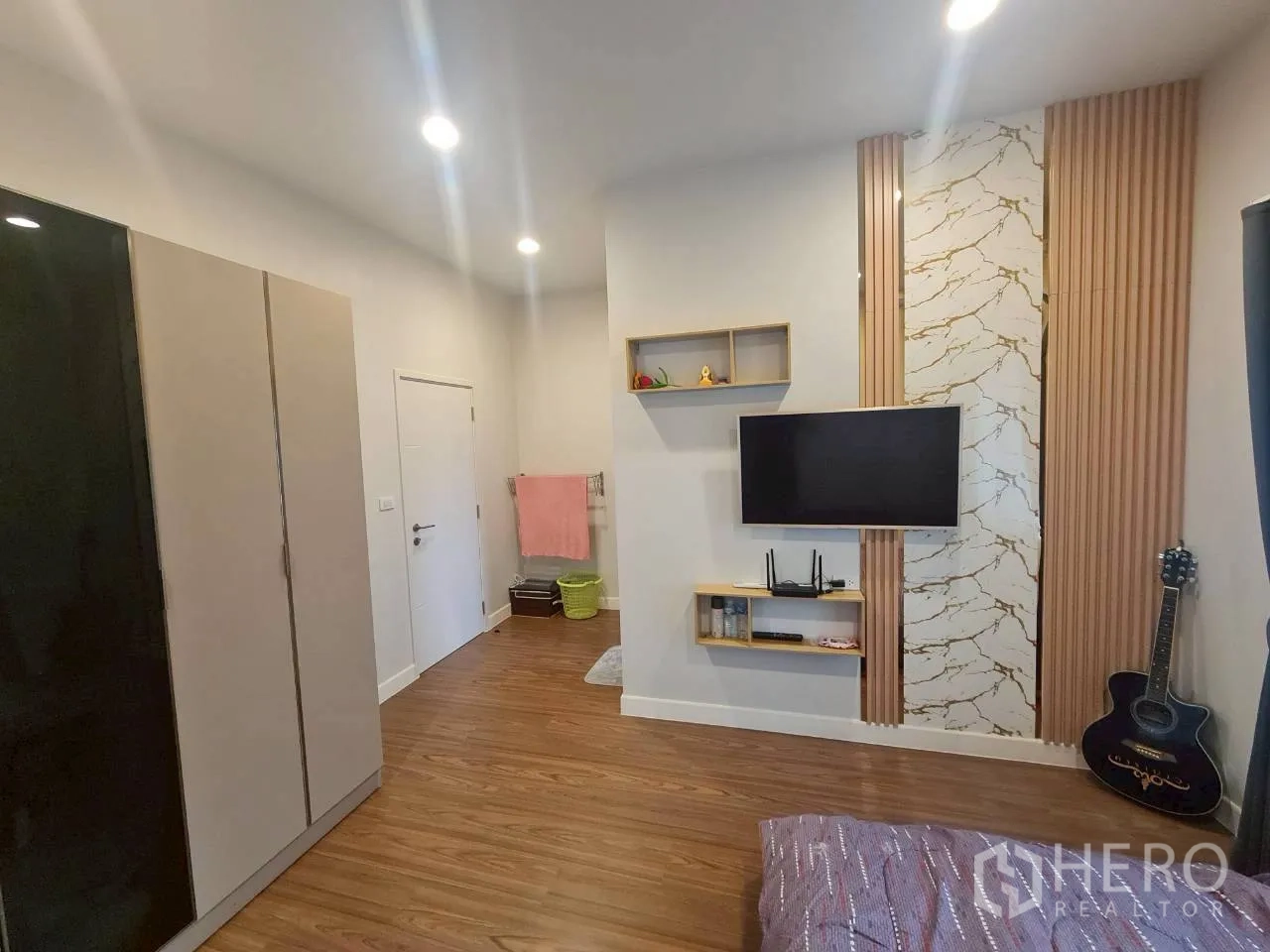 Detached House for rent or sale in Lam Luk Ka, Pathum Thani - Third bedroom from another angle showing wardrobe and feature wall panels.