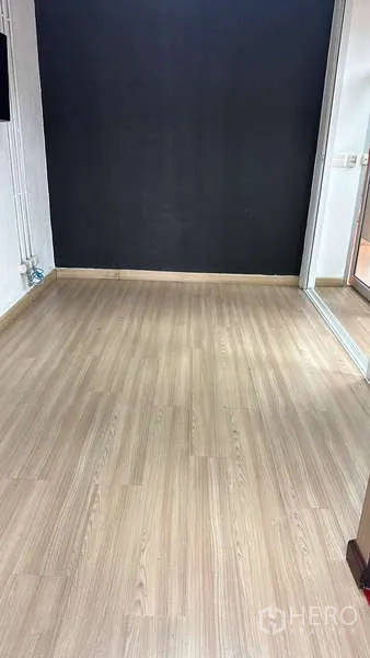 Office Space for rent - Compact private office with wood flooring and a dark feature wall.