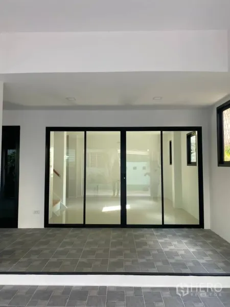 Home Office for sale - Covered entry with large sliding glass doors and a tiled forecourt at the home office.