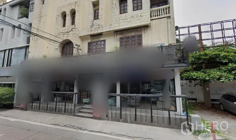 Retail Space for rent in Watthana, Bangkok - Street view of a low-rise building with raised terrace and glass-front retail unit.