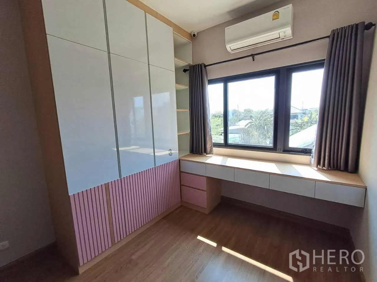 Townhouse for rent in Bang Kapi, Bangkok - Bedroom with built-in wardrobe, long desk under the window and air conditioner.