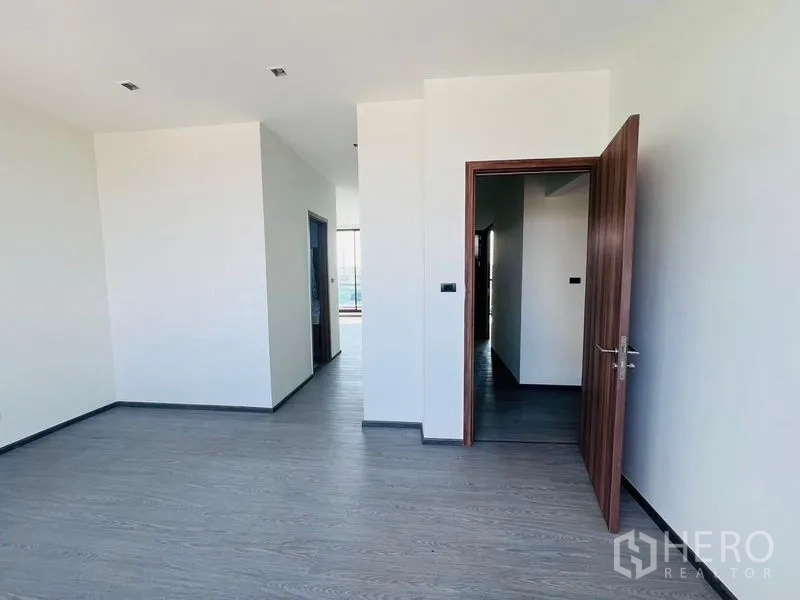 Home Office for sale in Bang Khen, Bangkok - Private office area with simple finishes, wooden door and access to adjoining rooms.