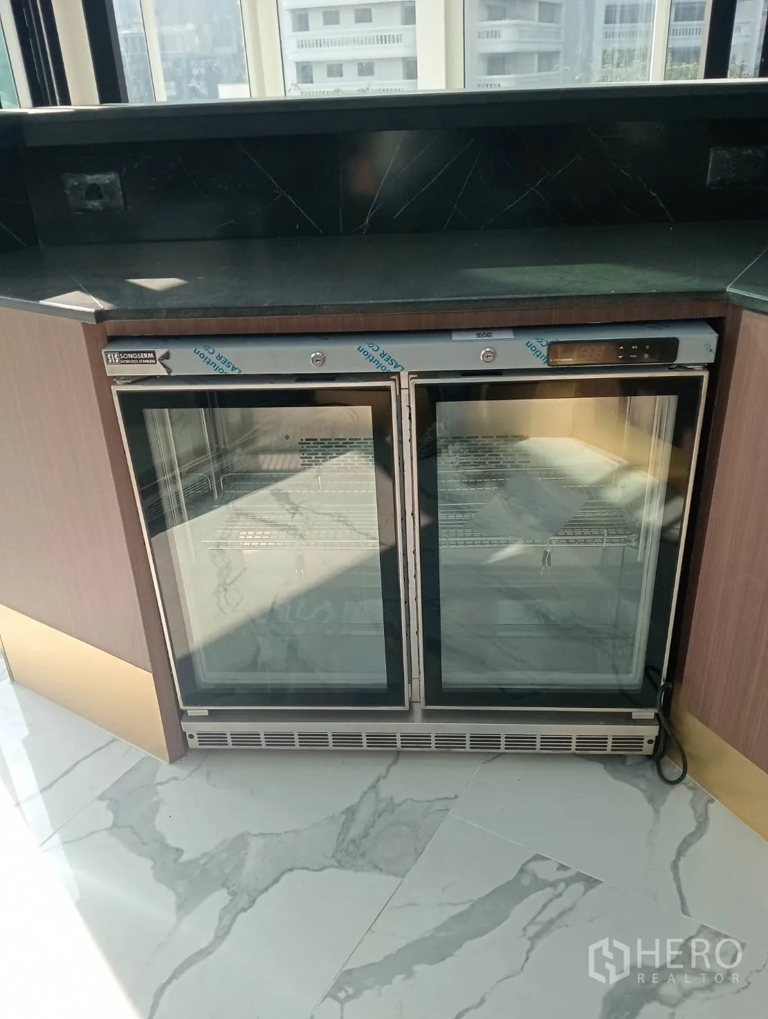Retail Space for rent - Stainless sink and wood cabinet with black countertop.