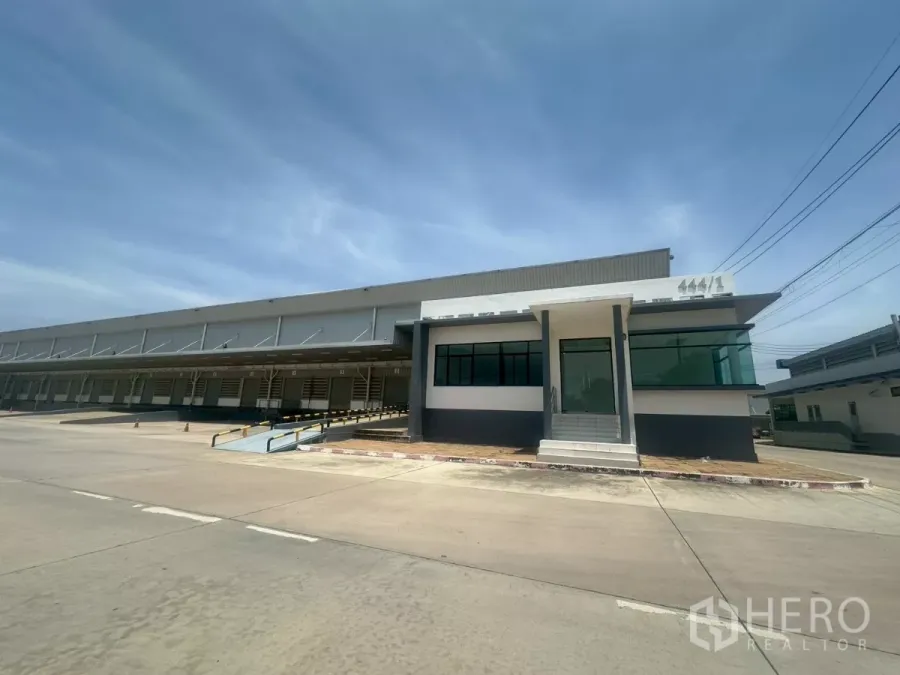 货栈 出租在Bang Phli, Samut Prakan - 仓库前方办公室与多组带雨棚的装卸月台。