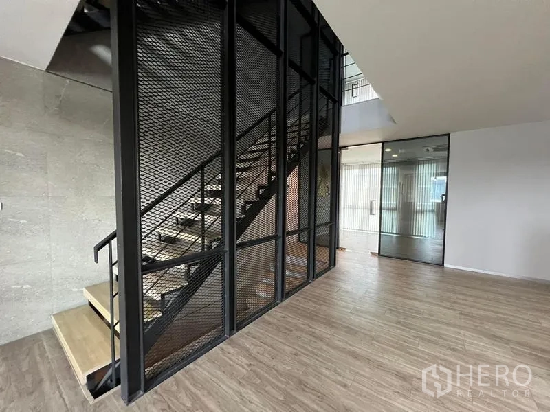 Home Office for rent in Bueng Kum, Bangkok - Ground floor area with mesh stair enclosure and glass entry door.