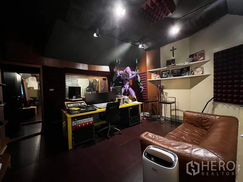 Townhouse for rent - Soundproofed recording studio control room with mixing desk and sofa.