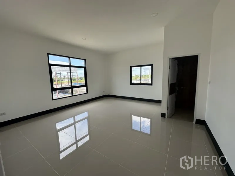 Factory for rent or sale in Sai Noi, Nonthaburi - Clean tiled restroom with window, sink and toilet inside the factory office.