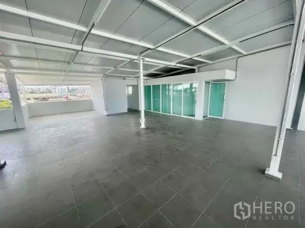 Home Office for rent or sale in Bang Kapi, Bangkok - Bright workspace featuring glass partitions and sliding doors leading to a balcony.