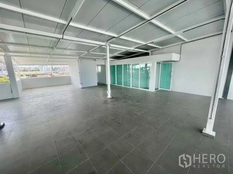 Home Office for rent or sale in Bang Kapi, Bangkok - Bright workspace featuring glass partitions and sliding doors leading to a balcony.