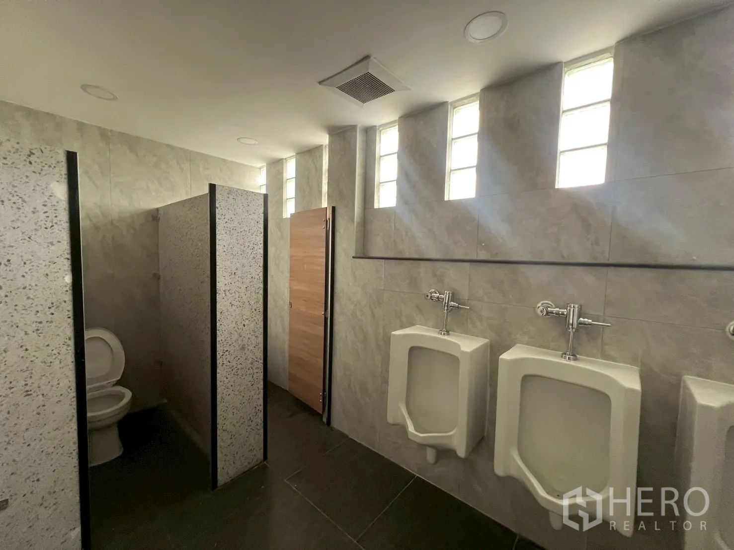 Office Space for rent in Watthana, Bangkok - Men’s restroom with urinals, stalls and tiled walls.