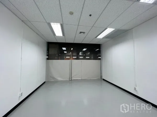Retail Space for rent in Watthana, Bangkok - Rectangular shop layout facing a glass entrance, with clean white walls and ample lights.