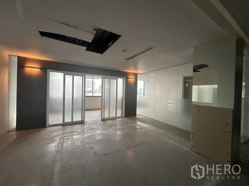 Office Space for rent in Khlong Toei, Bangkok - Meeting room with sliding frosted doors, accent wall lights and partial ceiling panel.