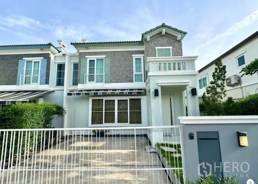 Detached House for rent or sale in Prawet, Bangkok - Another front exterior view highlighting gated parking and second-floor balcony.