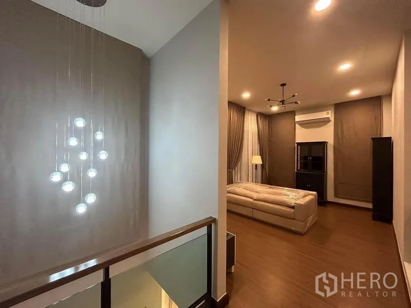 Detached House for rent - Upper-floor family lounge with chandelier, wood flooring and full-length curtains.