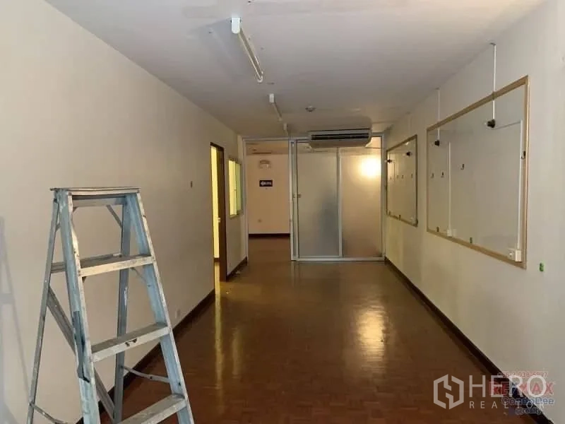 Retail Space for rent in Watthana, Bangkok - Long interior corridor with parquet flooring, white walls, glass partition and ceiling strip lights.
