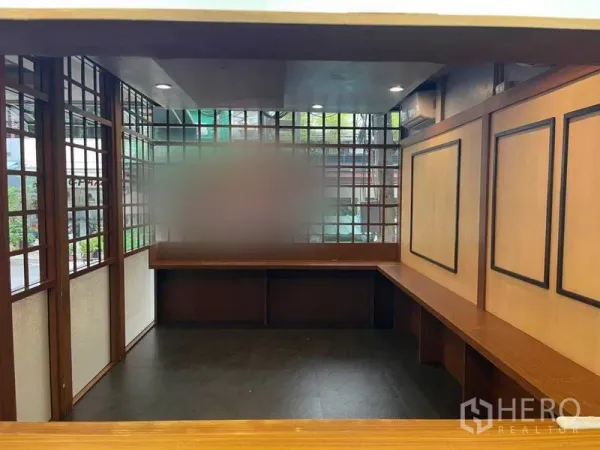 Retail Space for rent in Watthana, Bangkok - Open shop floor with wraparound counters, wooden lattice windows and recessed ceiling lights.