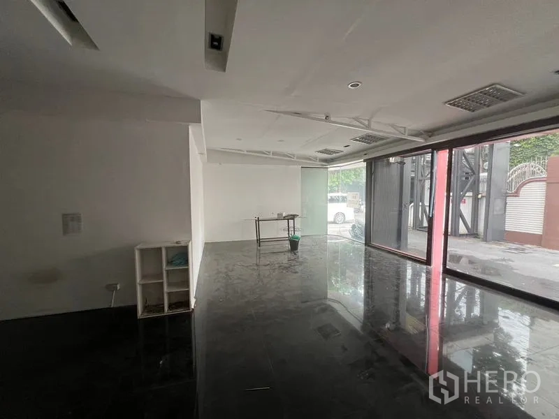 Retail Space for rent in Watthana, Bangkok - Long open retail area with panoramic glass frontage and clean white walls ready for fit-out.