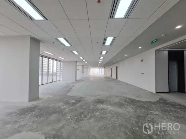 Office Space for rent in Chatuchak, Bangkok - Long rectangular office space with grid ceiling lights and concrete floor, ready for fit‑out.