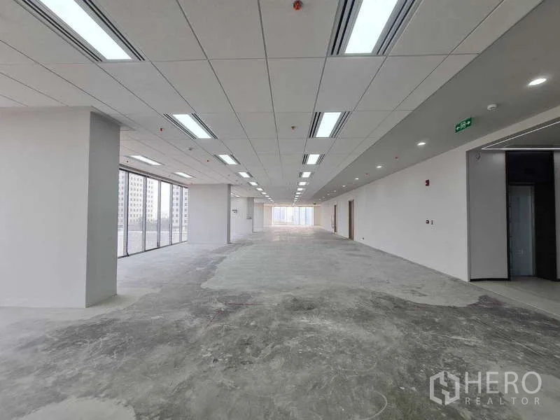 Office Space for rent in Chatuchak, Bangkok - Long rectangular office space with grid ceiling lights and concrete floor, ready for fit‑out.