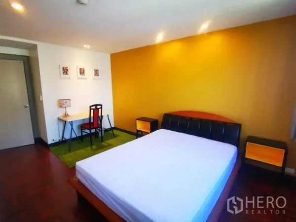 Condominium for rent in Khlong Toei, Bangkok - Alternate view of bedroom showing bed, work desk, nightstands and recessed ceiling lights.