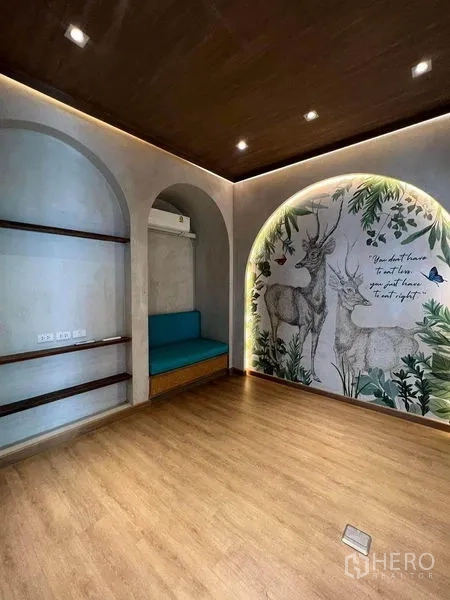 Retail Space for rent in Phaya Thai, Bangkok - Feature wall with deer mural, arched niche seating, and shelving.
