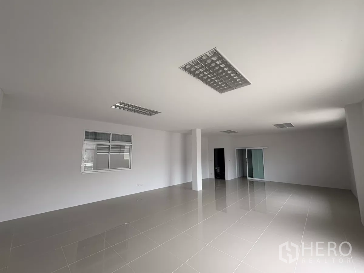 Factory for rent in Phra Samut Chedi, Samut Prakan - Another view of the spacious office level with windows and a sliding glass door.