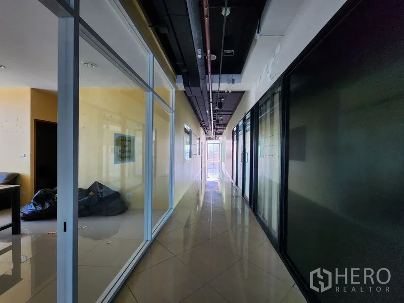 Retail Space for rent in Bang Rak, Bangkok - Corridor lined with glass partitions and glossy flooring.
