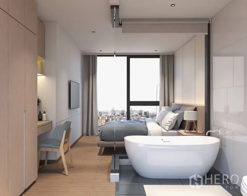 Condominium for rent or sale in Bang Rak, Bangkok - Freestanding bathtub beside a glass partition facing the bed with a large window and urban views.