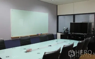 Office Space for rent in Bang Na, Bangkok - Conference room with glass table, leather chairs, wall whiteboard, and TV media setup in a Bangkok office.