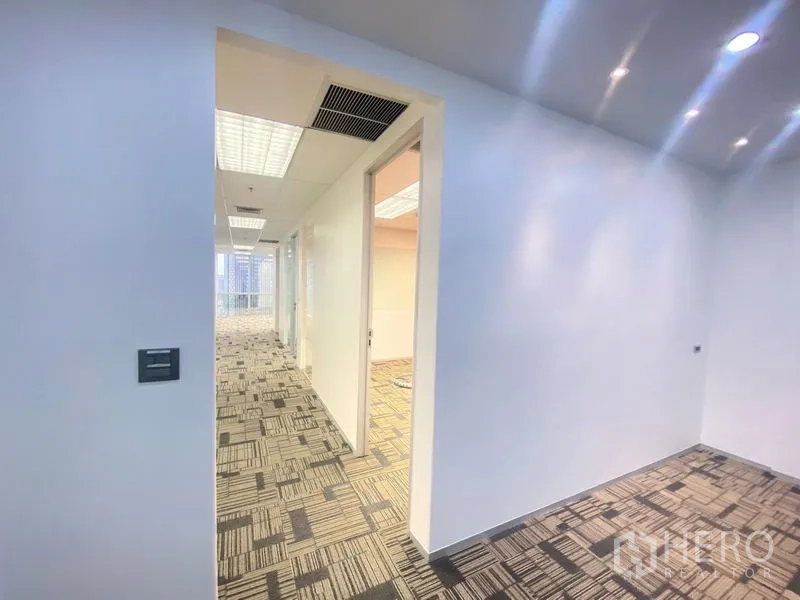 Office Space for rent in Chatuchak, Bangkok - Entrance nook leading to hallway with spotlights, offices, and city-facing glass rooms.